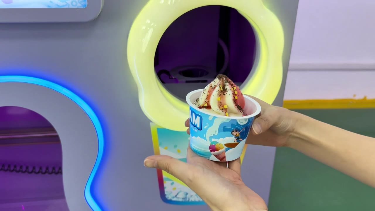 CT-XG260 video frame showing a finished soft serve cup at the pickup opening
